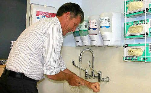 Critical Care Area clinical nurse consultant Mark McLennan demonstrating how hand washing can stop the spread of flu and ease pressure on hospitals.